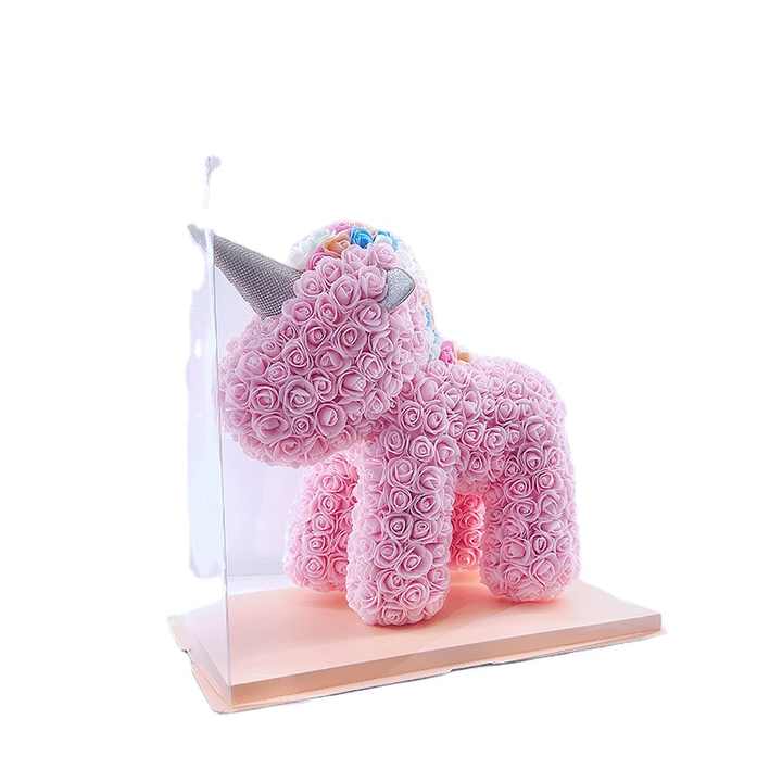 Teddy bear, beautiful soap doll holding flowers in the shape of a pink bear 
